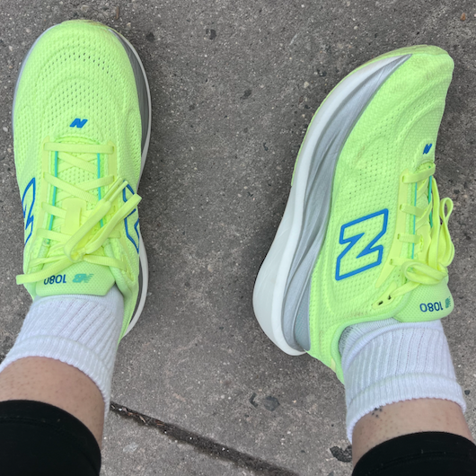 Bright neon yellow athletic shoes worn with white socks.