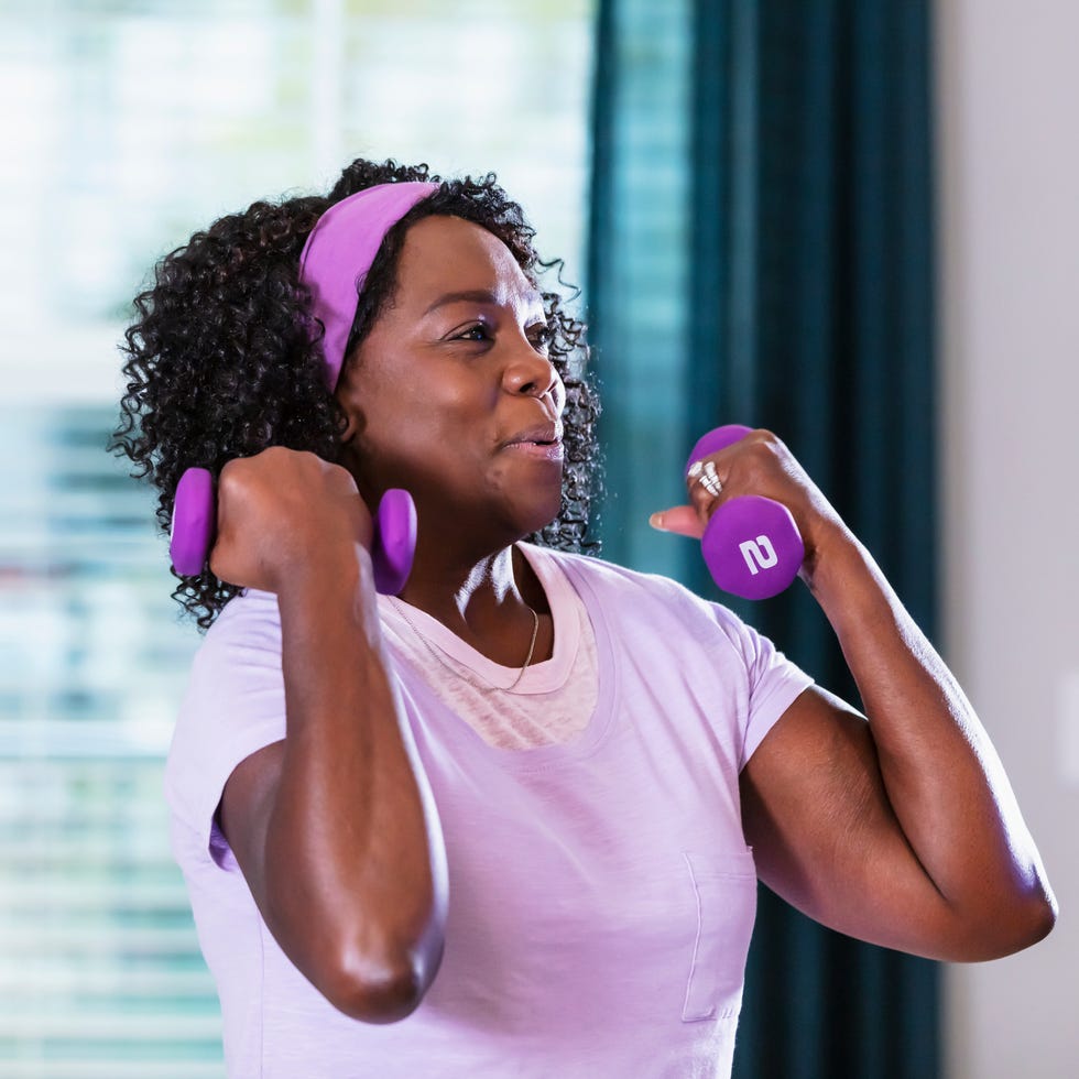 senior woman working out at home in her living room