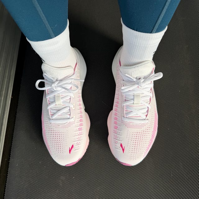 Footwear with a sporty design worn with athletic leggings on a gym floor. Footwear with a sporty design worn with athletic leggings on a gym floor.