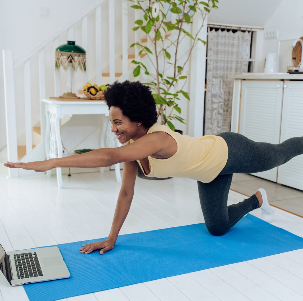 african american woman practicing pilates at home