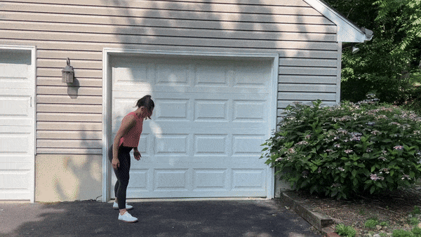 dynamic stretches inchworms trainer doing inchworms outside in front of garage