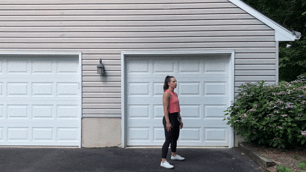 dynamic stretches squats trainer doing squats outside in front of garage