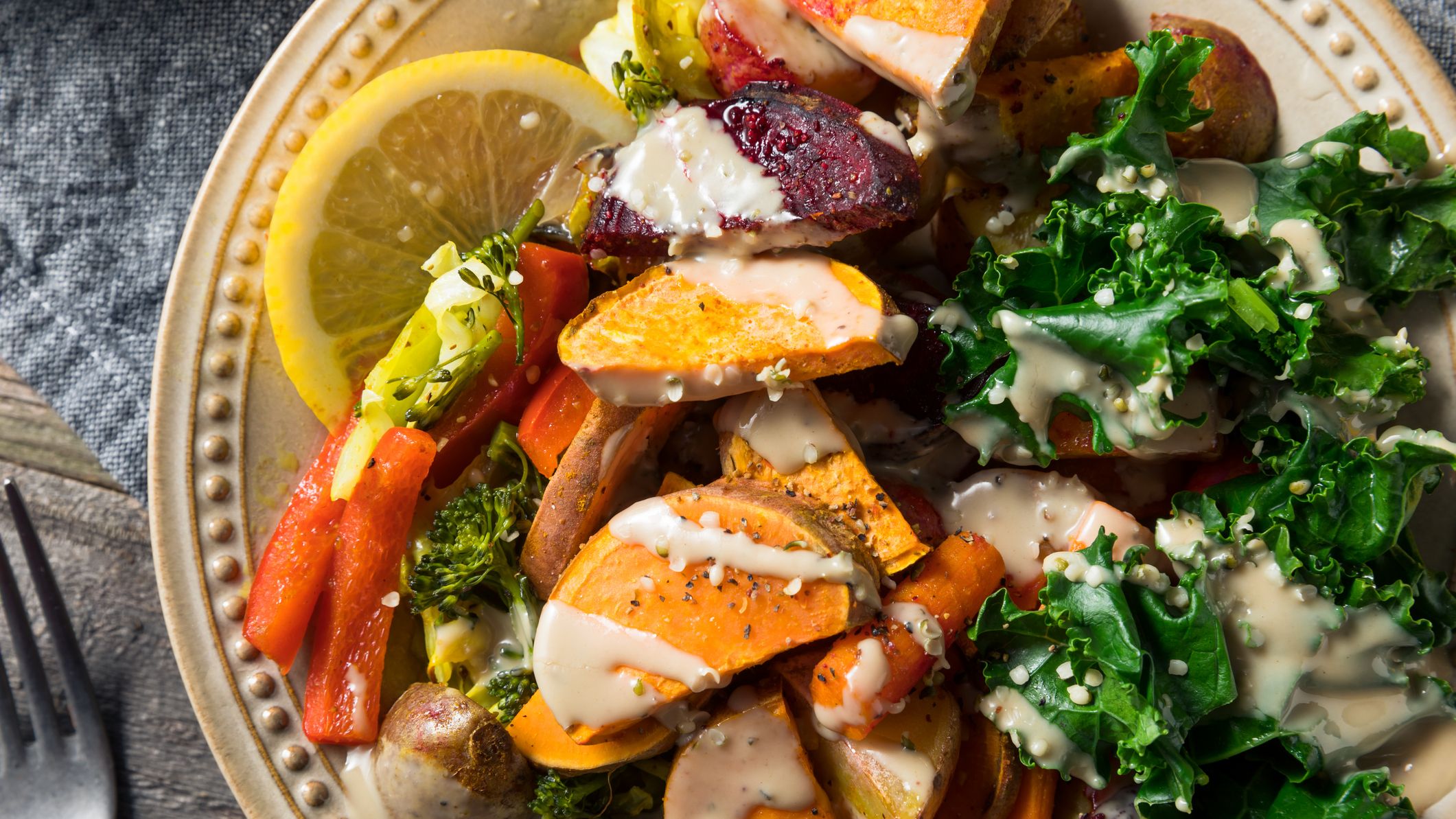 Bowl of vegetables with drizzle of tahini dressing